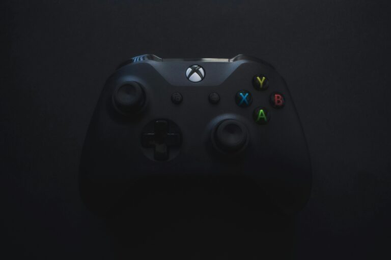 Xbox controller illuminated against a dark background, perfect for gaming themes.